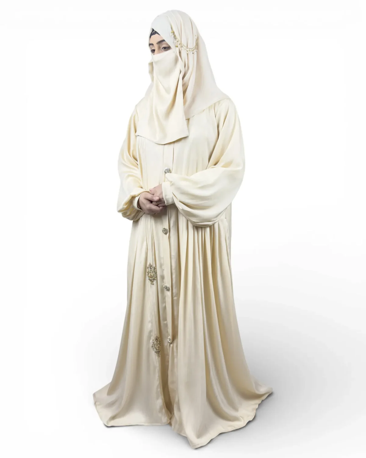 The Vanilla off-white pintucked abaya front view with gold chain headpiece jewelry