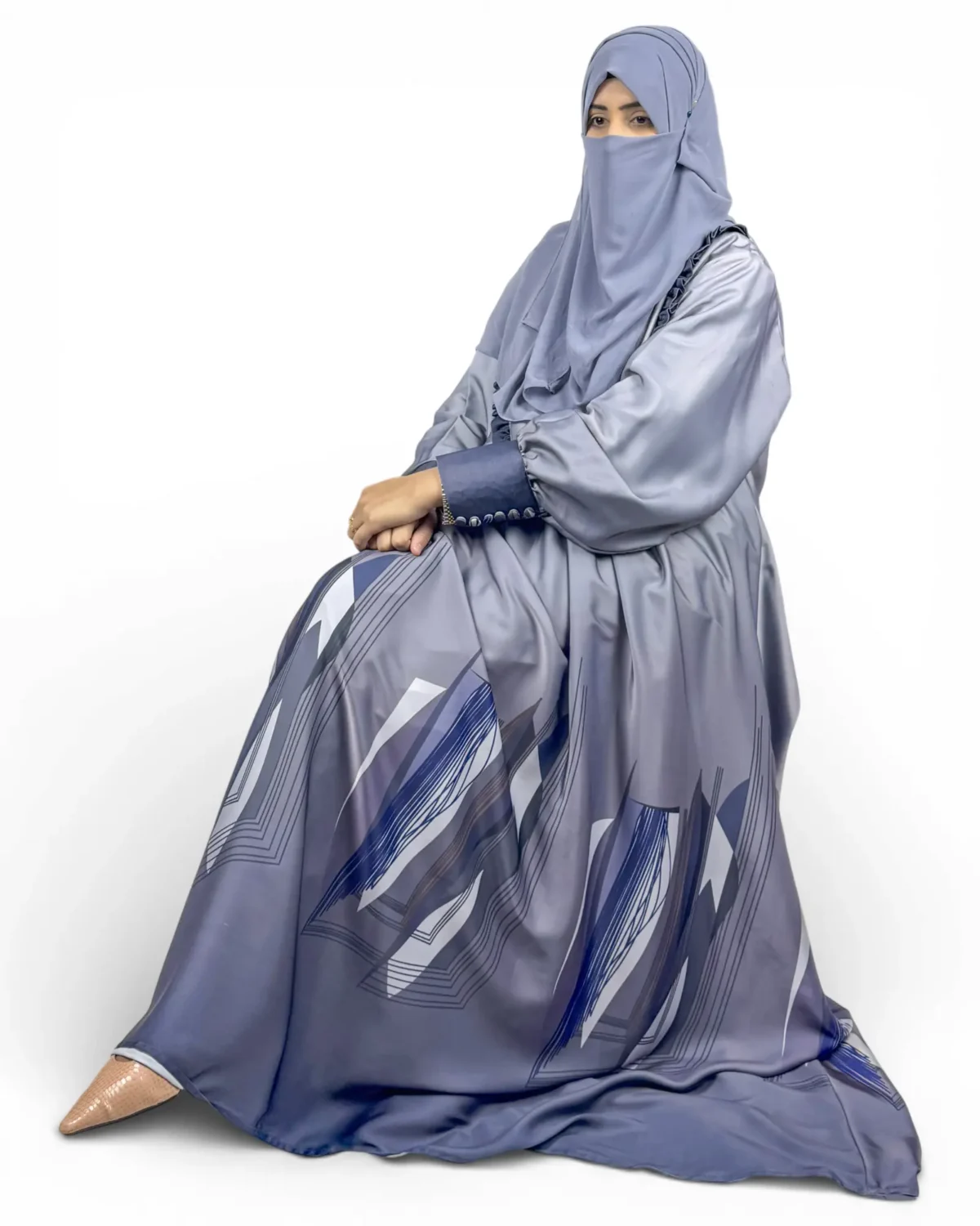 Azure Mist periwinkle abaya seated view with geometric angular chevron print at skirt