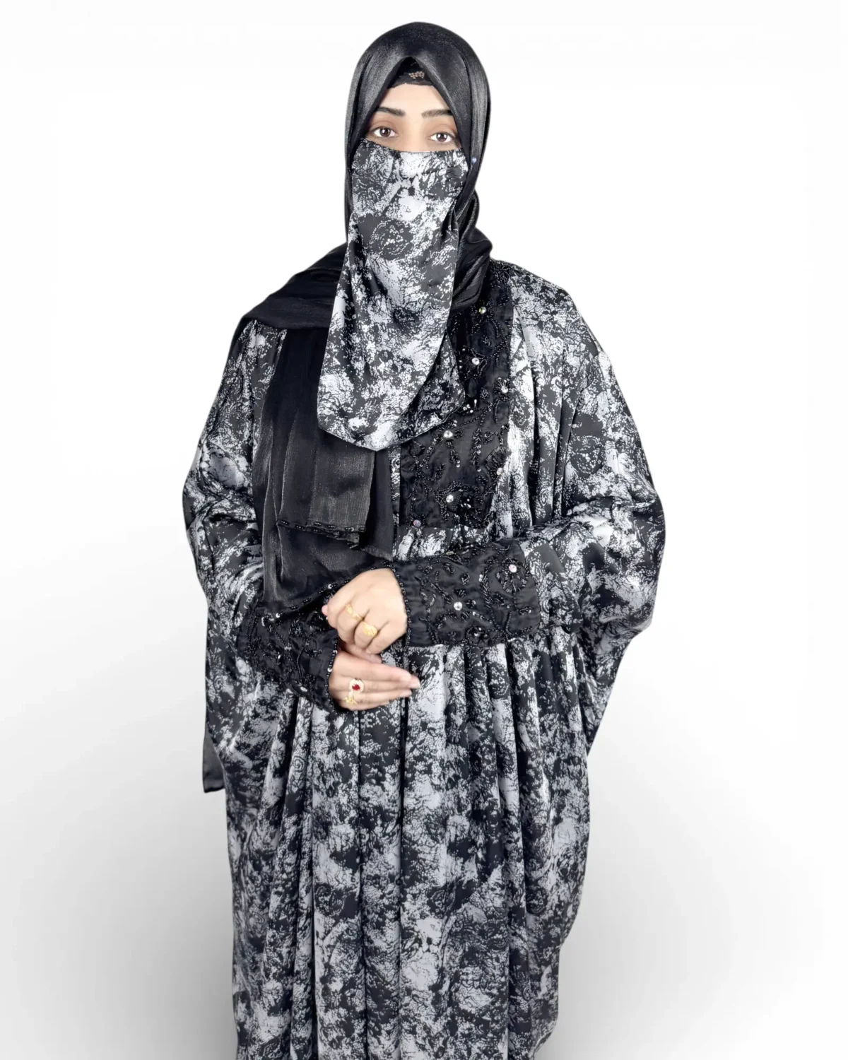 Midnight Snow satin abaya showing floral botanical print and black embroidered sleeve cuffs