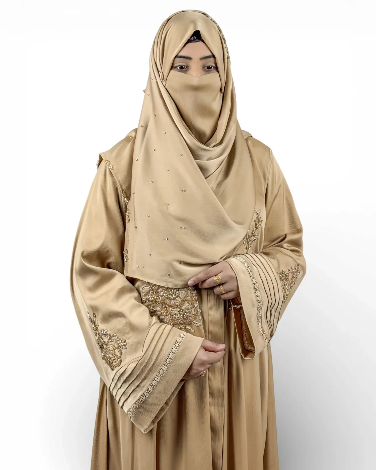Aura khaki camel abaya close-up of gold embroidery cluster and pintuck cuff with sequin trim