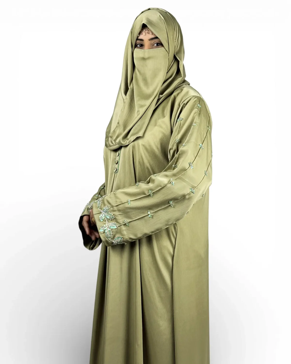 Olive Bloom olive green abaya angled view showing embroidery border at hem edge