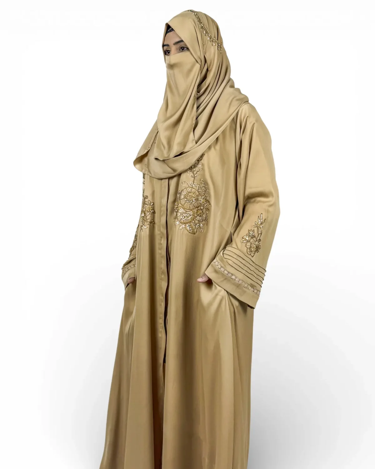 Aura golden abaya showing embroidered neckline with gold matching hijab and crystal pin accents