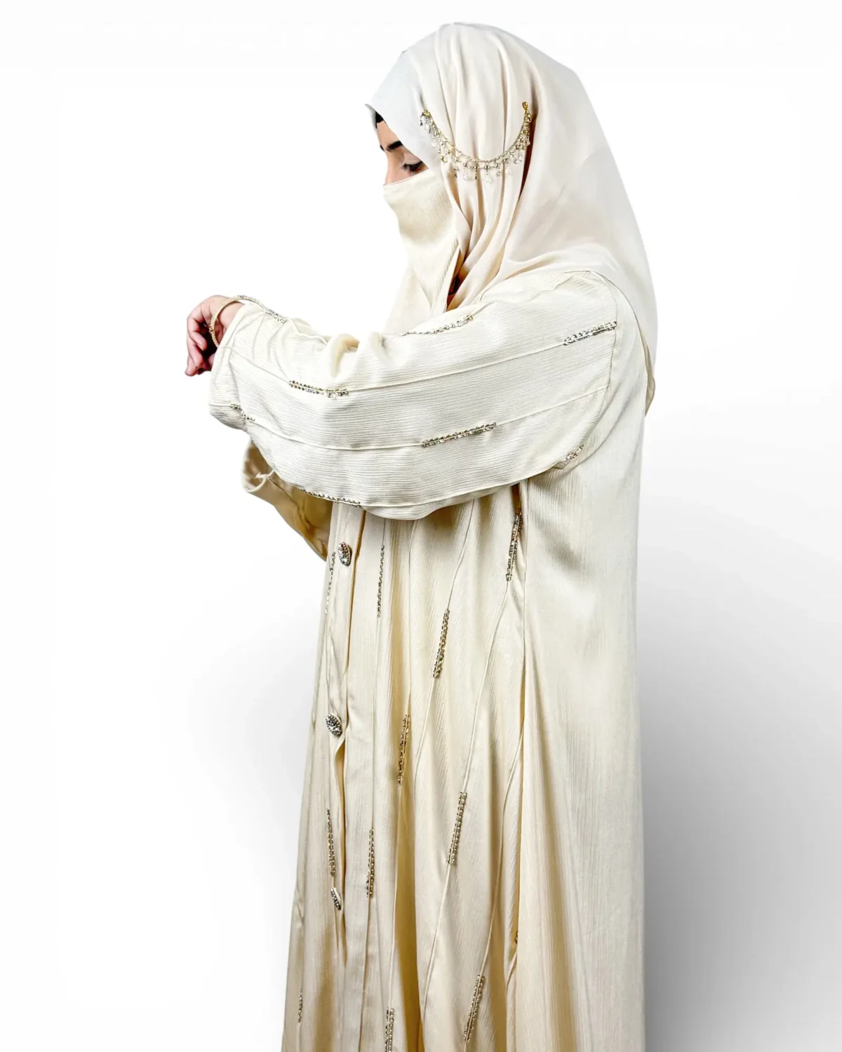 Royal Ivory abaya detail showing gold and silver embroidered motifs across sleeve fabric