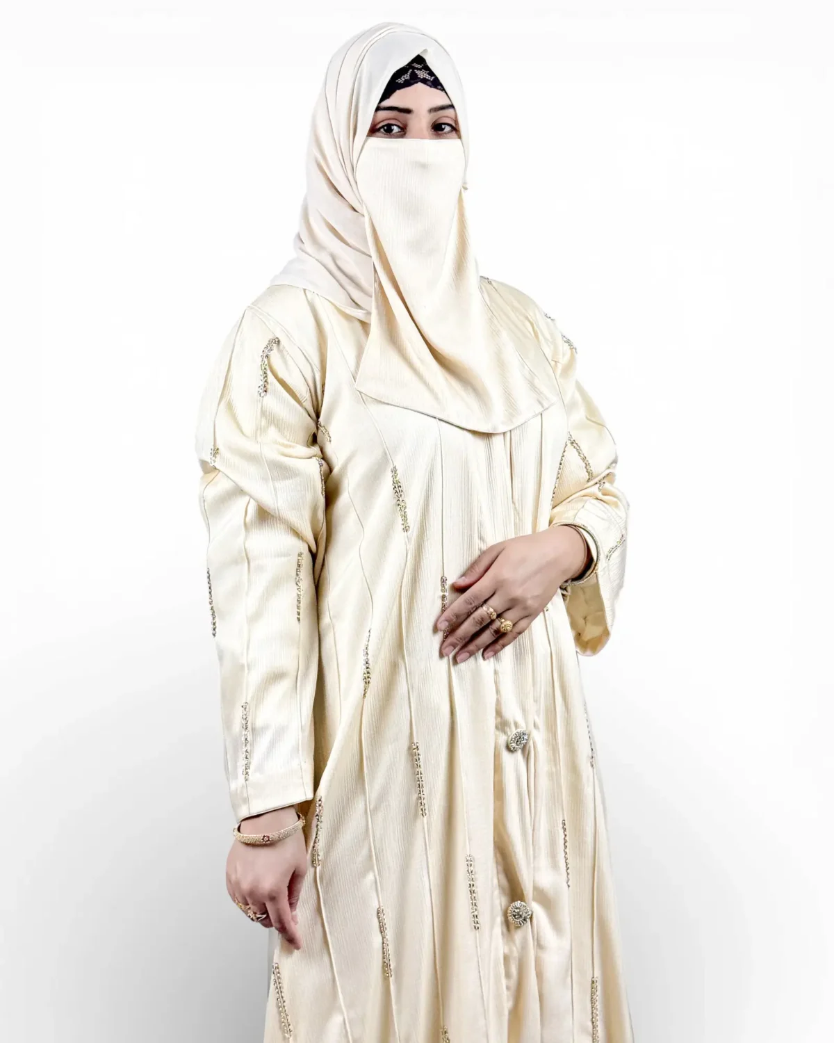 Royal Ivory ivory abaya showing vertical pintuck striping and scattered gold embroidered motifs