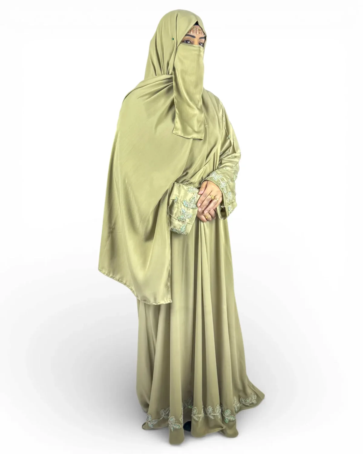 Olive Bloom olive abaya three-quarter view with floral embroidered sleeves and gold chain headpiece