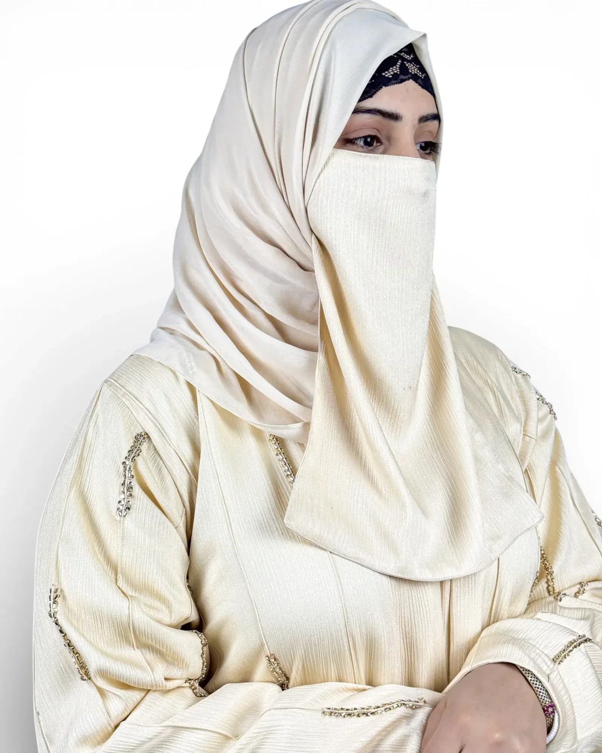Royal Ivory cream abaya three-quarter view with gold and silver dash embroidery motifs