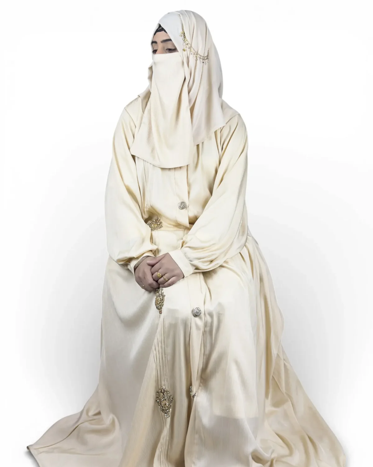 The Vanilla cream abaya with round decorative buttons and jeweled ornament appliqués