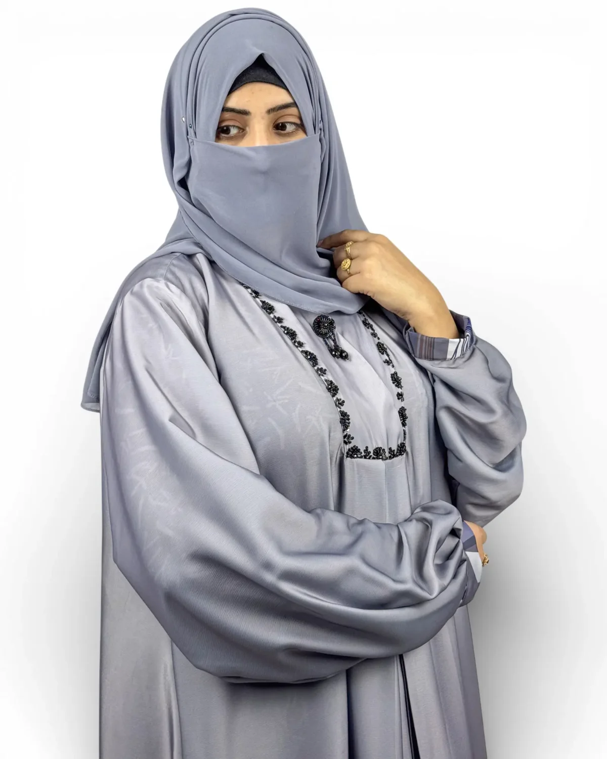 Skyline steel-blue satin abaya side view with geometric hem print and scarf
