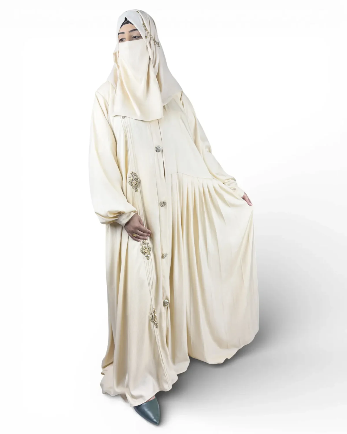 The Vanilla abaya close-up showing ornate jeweled brooch ornament detail on front
