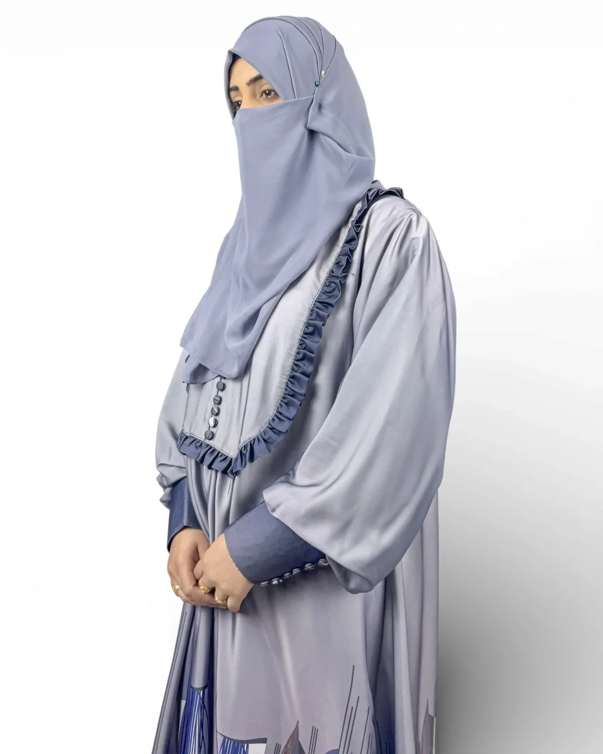 Azure Mist blue-grey abaya close-up showing ruffle front trim detail with small button fastening
