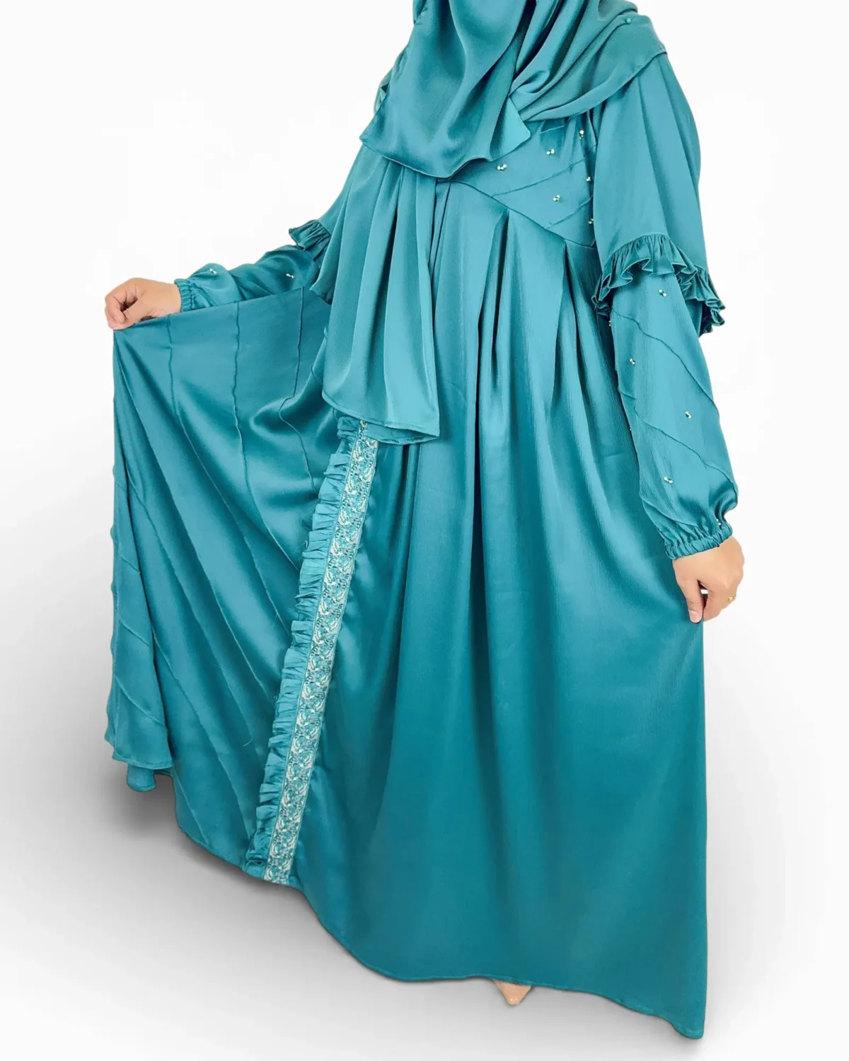 Ocean Lace abaya close-up showing embroidered lace trim panel with ruffle edge