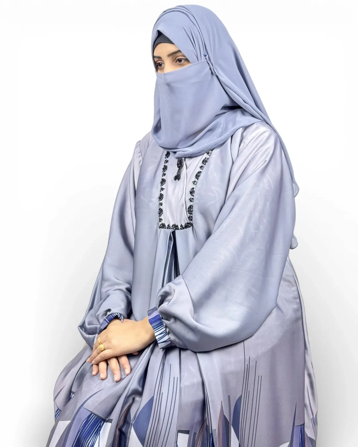 Skyline abaya close-up of black floral embroidery at neckline and blue cuff detail