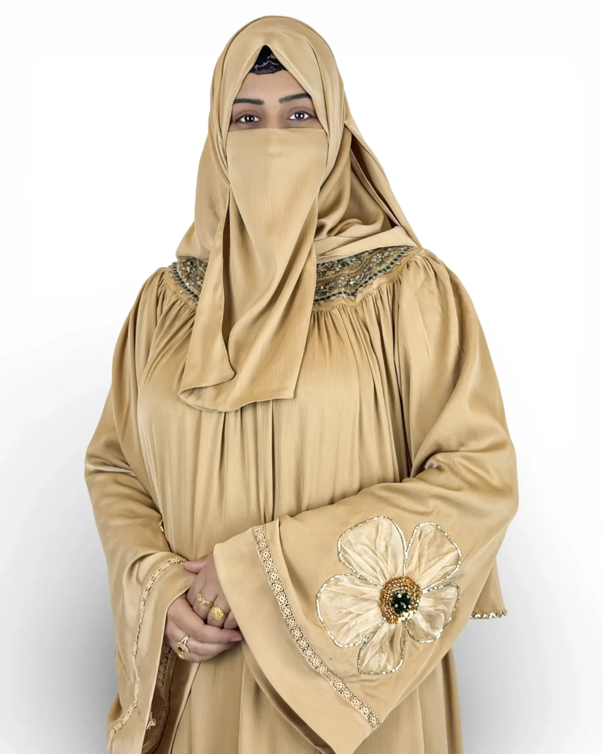 Golden Bloom champagne abaya showing 3D satin flower appliqués at bodice and sleeves