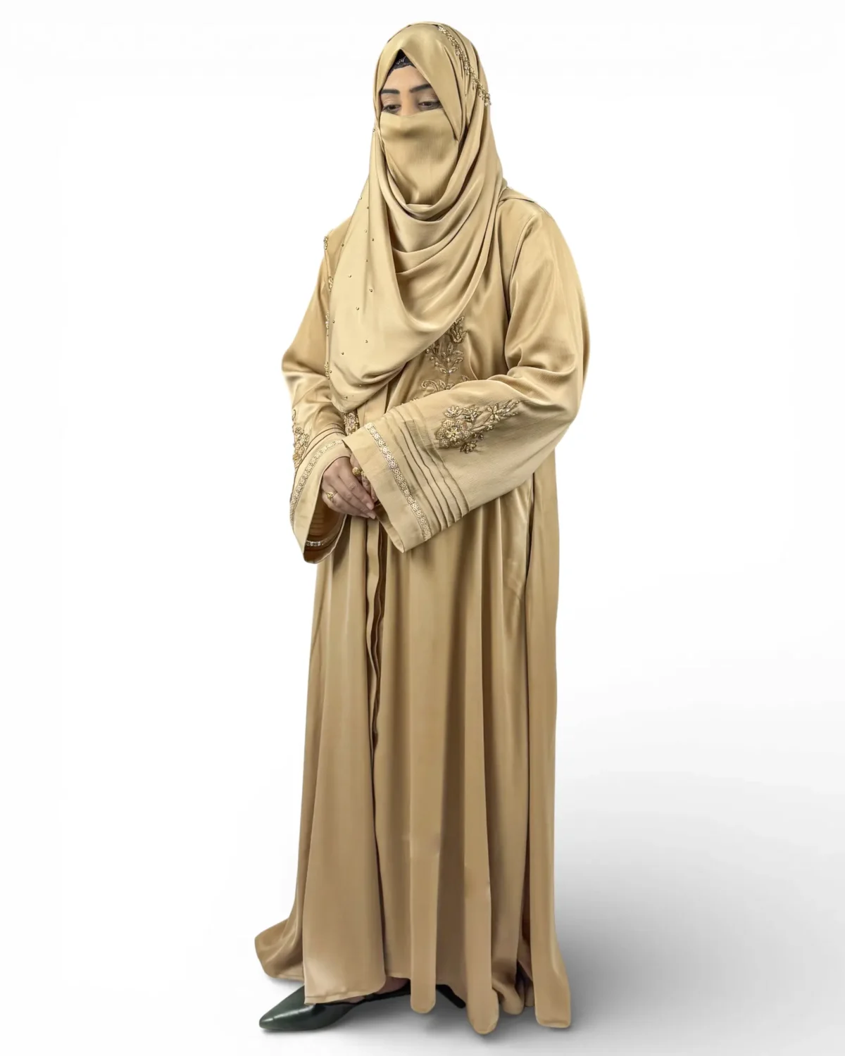 Aura camel satin abaya showing pintuck textured fabric with gold embroidery on sleeves