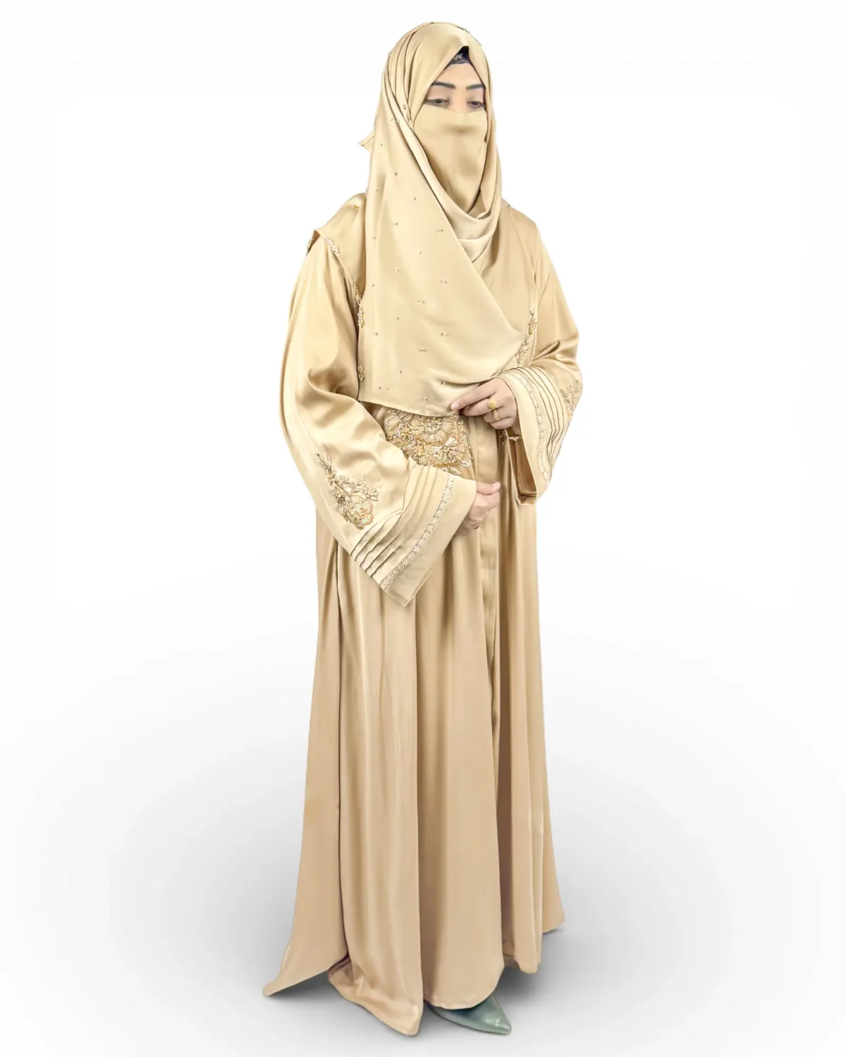 Aura camel abaya side view showing pintucked cuffs with gold sequin lace trim bands