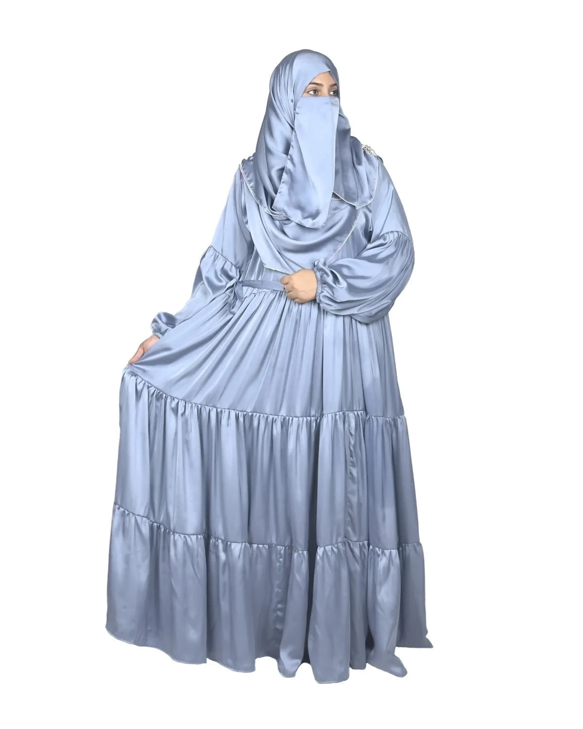 Blue Tiers dusty blue abaya front three-quarter view with softly tiered high-sheen satin skirt