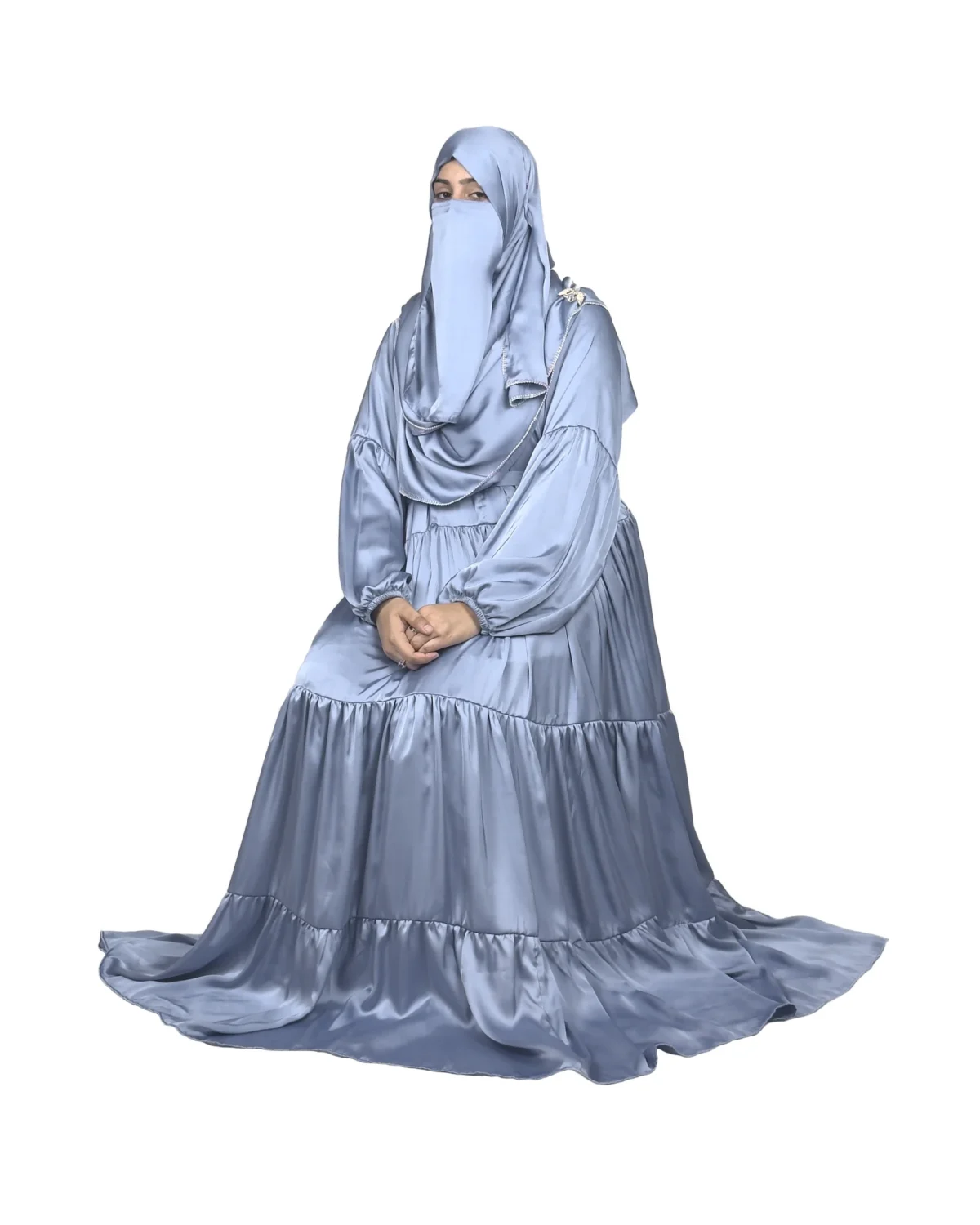 Blue Tiers dusty blue abaya front three-quarter view with softly tiered high-sheen satin skirt