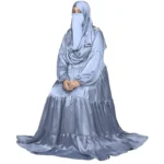 Blue Tiers dusty blue abaya front three-quarter view with softly tiered high-sheen satin skirt