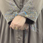 Copper Lily copper / warm dark brown abaya close-up of the sequinned flower petals on the cuff