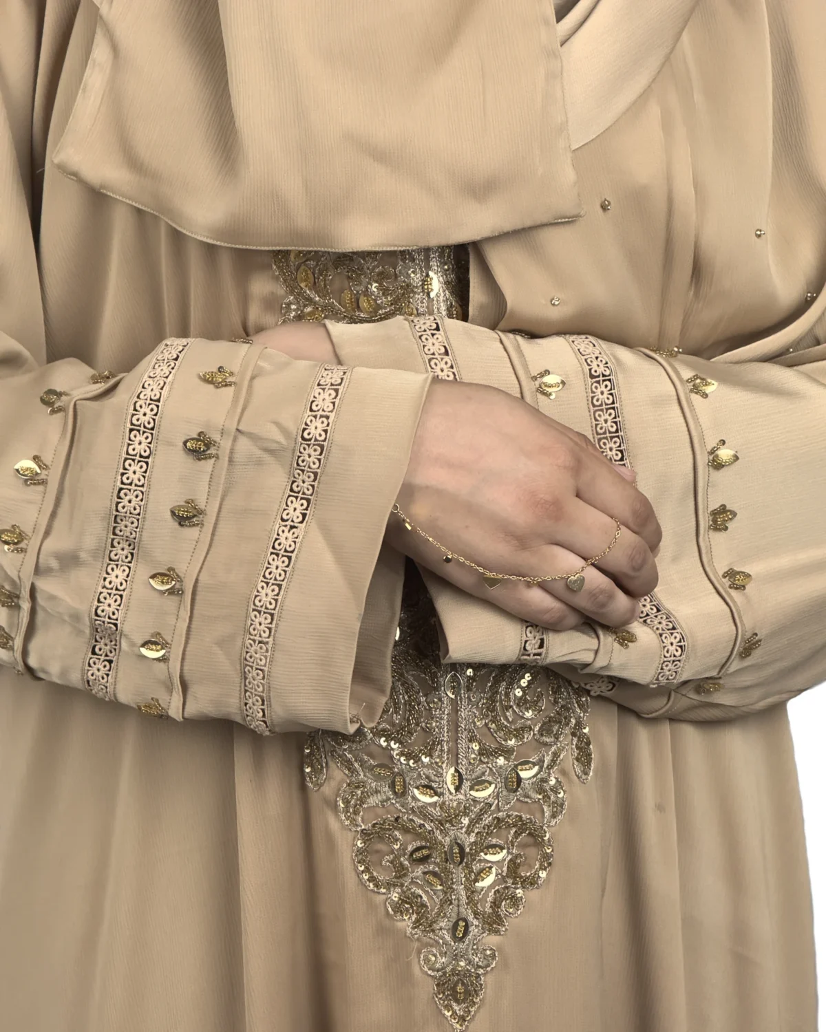 Desert Gold camel / sand beige abaya close-up of the gold-beaded medallion and gold-banded cuff