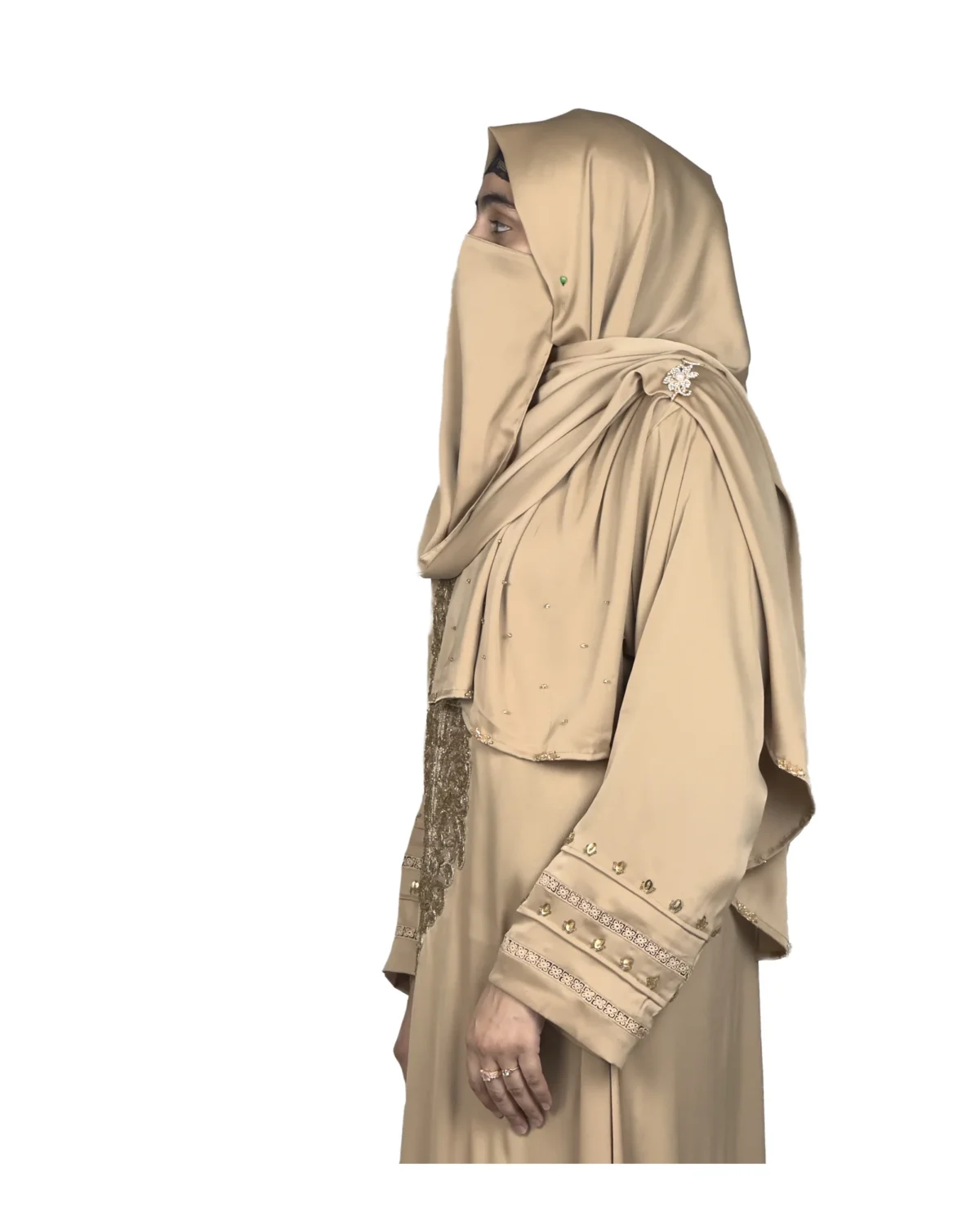 Desert Gold camel / sand beige abaya side profile view with ornate gold-beaded medallion and gold-banded cuffs