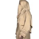 Desert Gold camel / sand beige abaya side profile view with ornate gold-beaded medallion and gold-banded cuffs