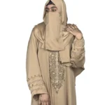 Desert Gold camel / sand beige abaya front three-quarter view with ornate gold-beaded medallion and gold-banded cuffs
