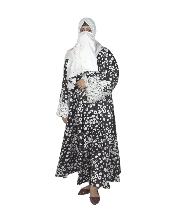 Frost Lace black & white abstract spot print abaya front view with black-and-white spot print with hand-embellished white lace cuffs