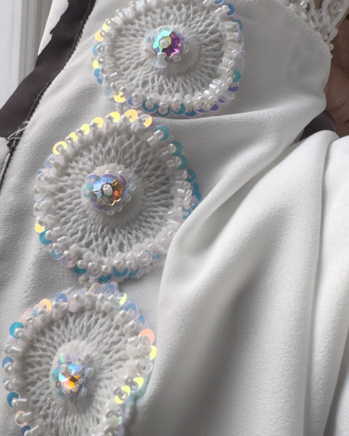 Frost Lace black & white abstract spot print abaya close-up of the hand-worked lace rosettes on the matching scarf