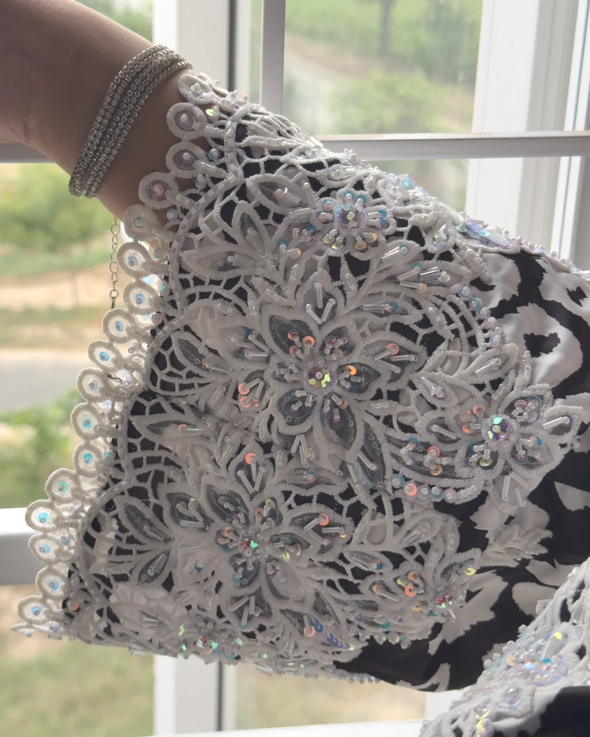 Frost Lace black & white abstract spot print abaya close-up of the white guipure lace cuff