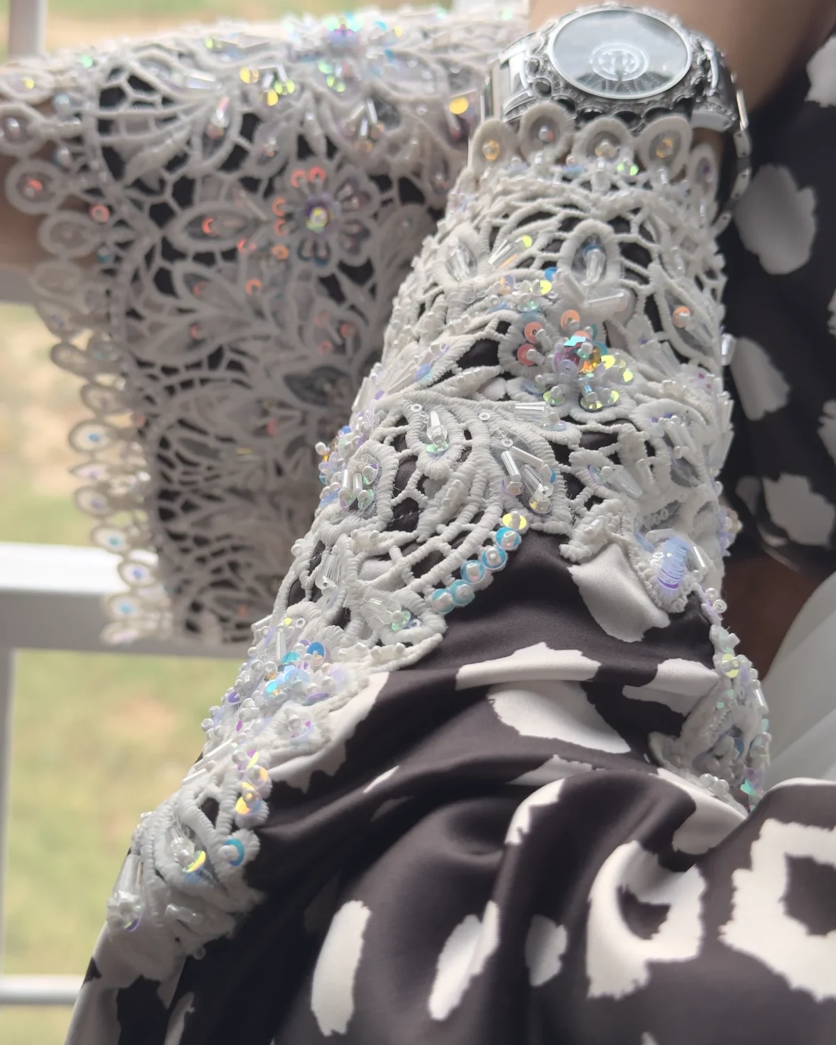 Frost Lace black & white abstract spot print abaya close-up of the sequins and stones hand-placed on the lace cuff