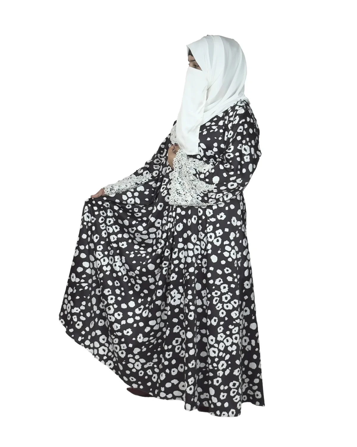 Frost Lace black & white abstract spot print abaya front three-quarter view with black-and-white spot print with hand-embellished white lace cuffs