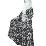 Frost Lace black & white abstract spot print abaya front three-quarter view with black-and-white spot print with hand-embellished white lace cuffs