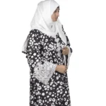 Frost Lace black & white abstract spot print abaya front three-quarter view with black-and-white spot print with hand-embellished white lace cuffs