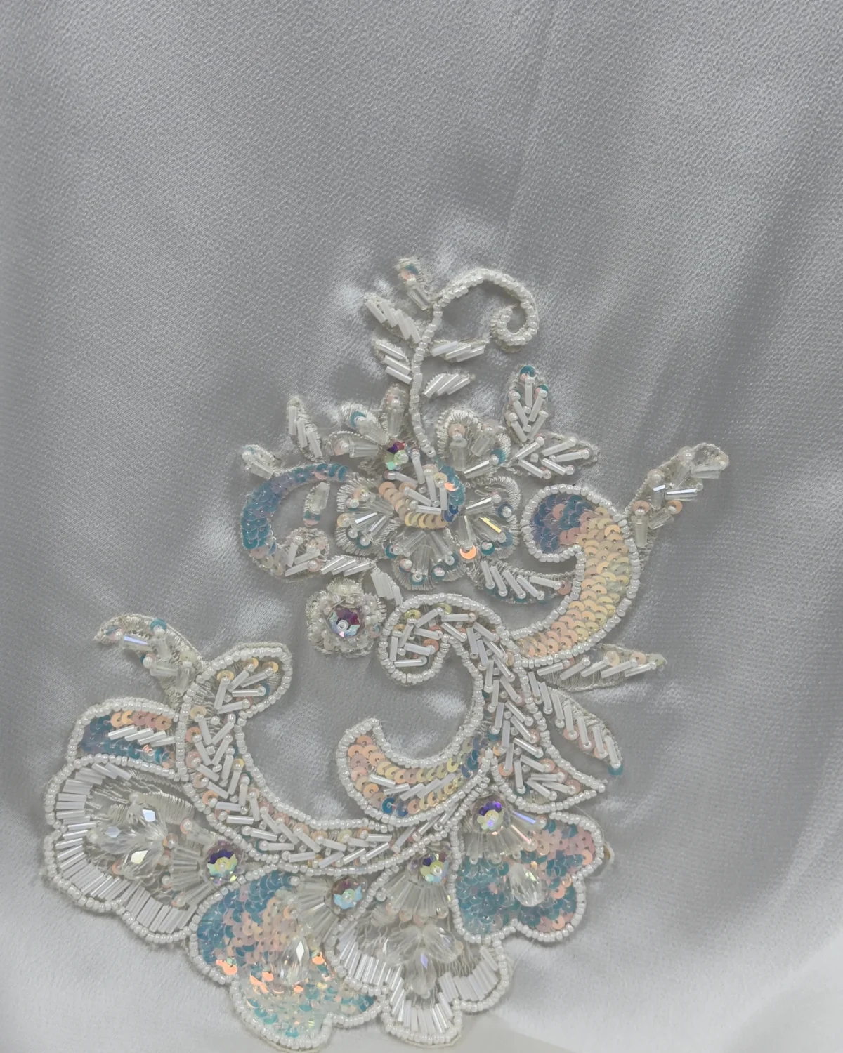 Marble Peacock black & white marble print with a white satin underlay abaya close-up of the hand-beaded paisley-floral appliqué