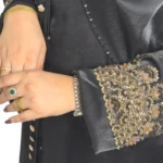 Onyx Gold black abaya close-up of the gold-and-black beaded scalloped cuff