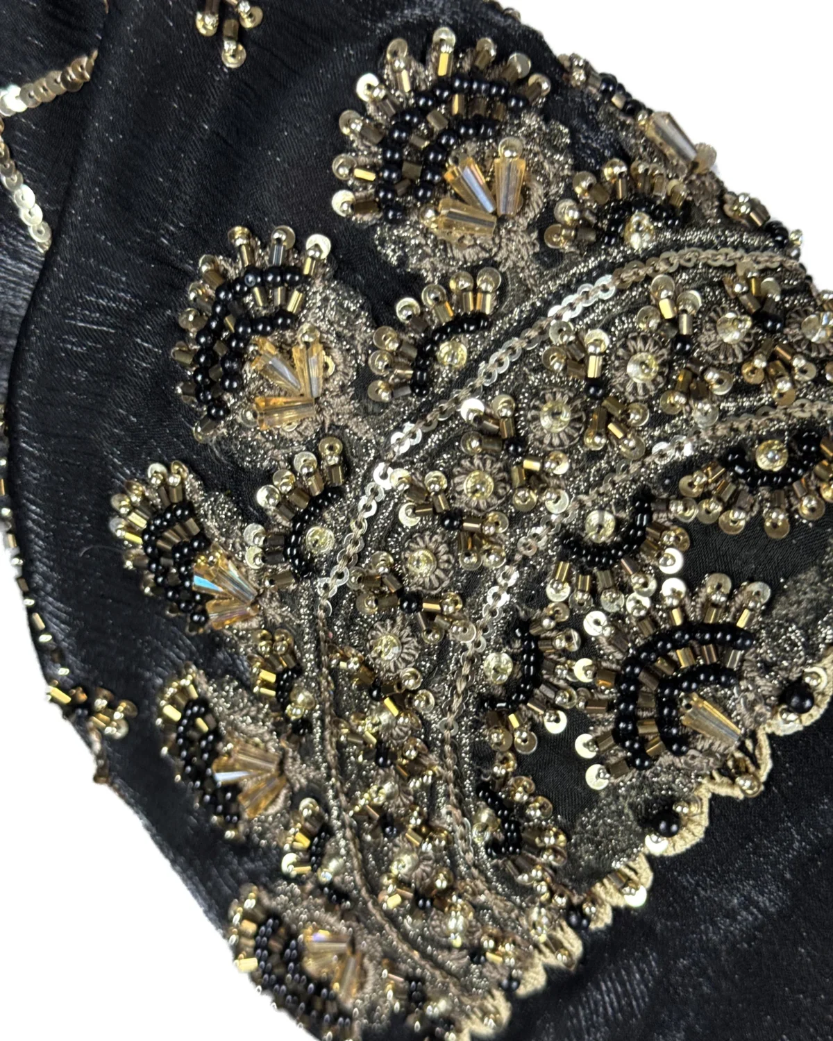 Onyx Gold black abaya close-up of the gold-and-black beaded scalloped cuff