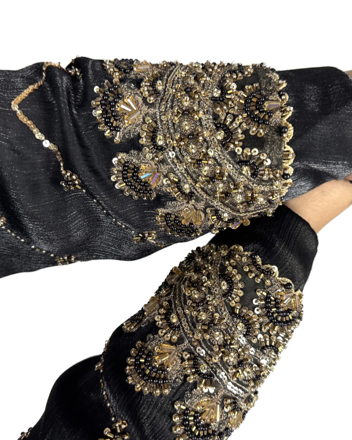 Onyx Gold black abaya close-up of the gold-and-black beaded scalloped cuff