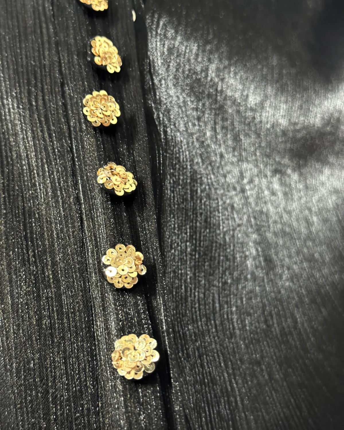 Onyx Gold black abaya close-up of the gold sequin-flower buttons