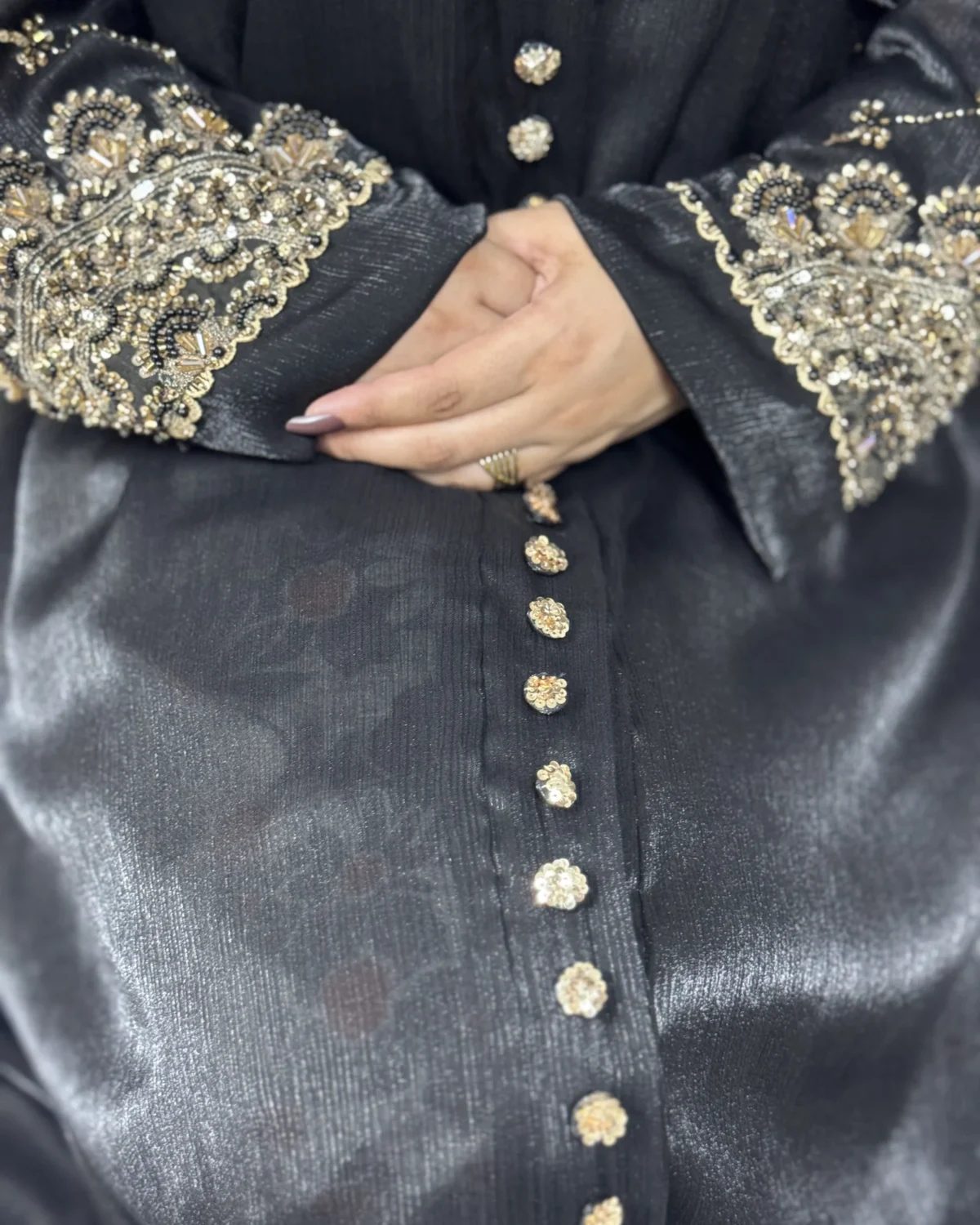 Onyx Gold black abaya close-up of the gold sequin-flower buttons