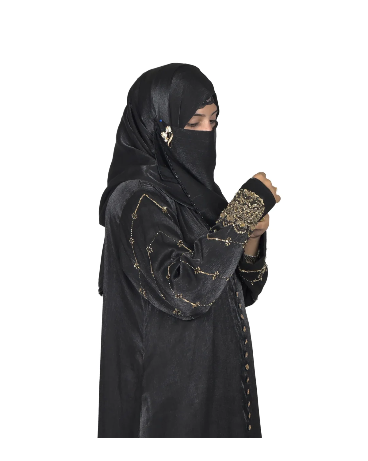 Onyx Gold black abaya side profile view with gold-and-black beaded cuffs and sequin-flower buttons