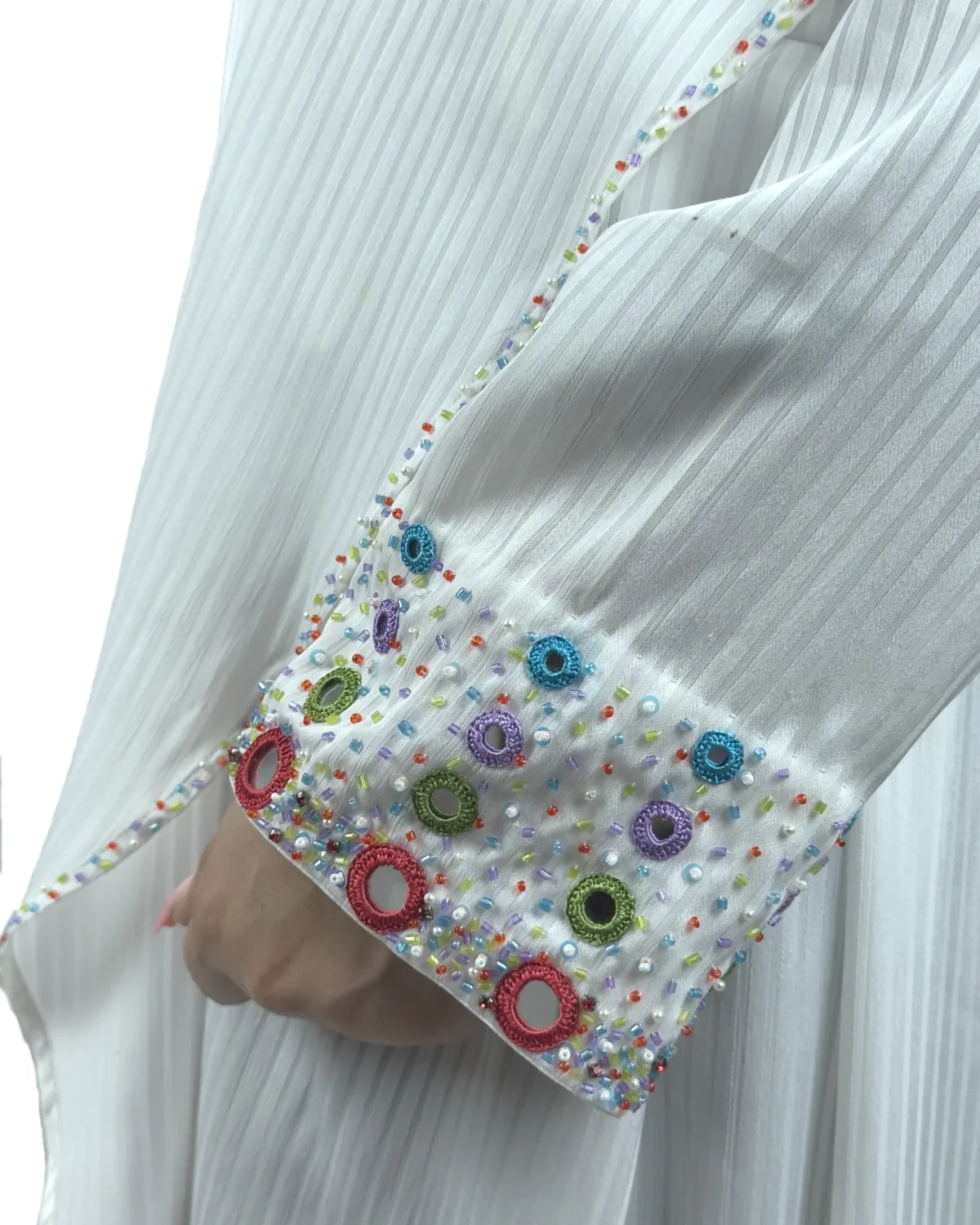 Pearl Drape white abaya close-up of the multicolour beaded rosettes on the cuff
