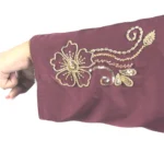 Ruby Bloom deep maroon / wine abaya close-up of the hand-beaded gold floral motif on the sleeve cuff