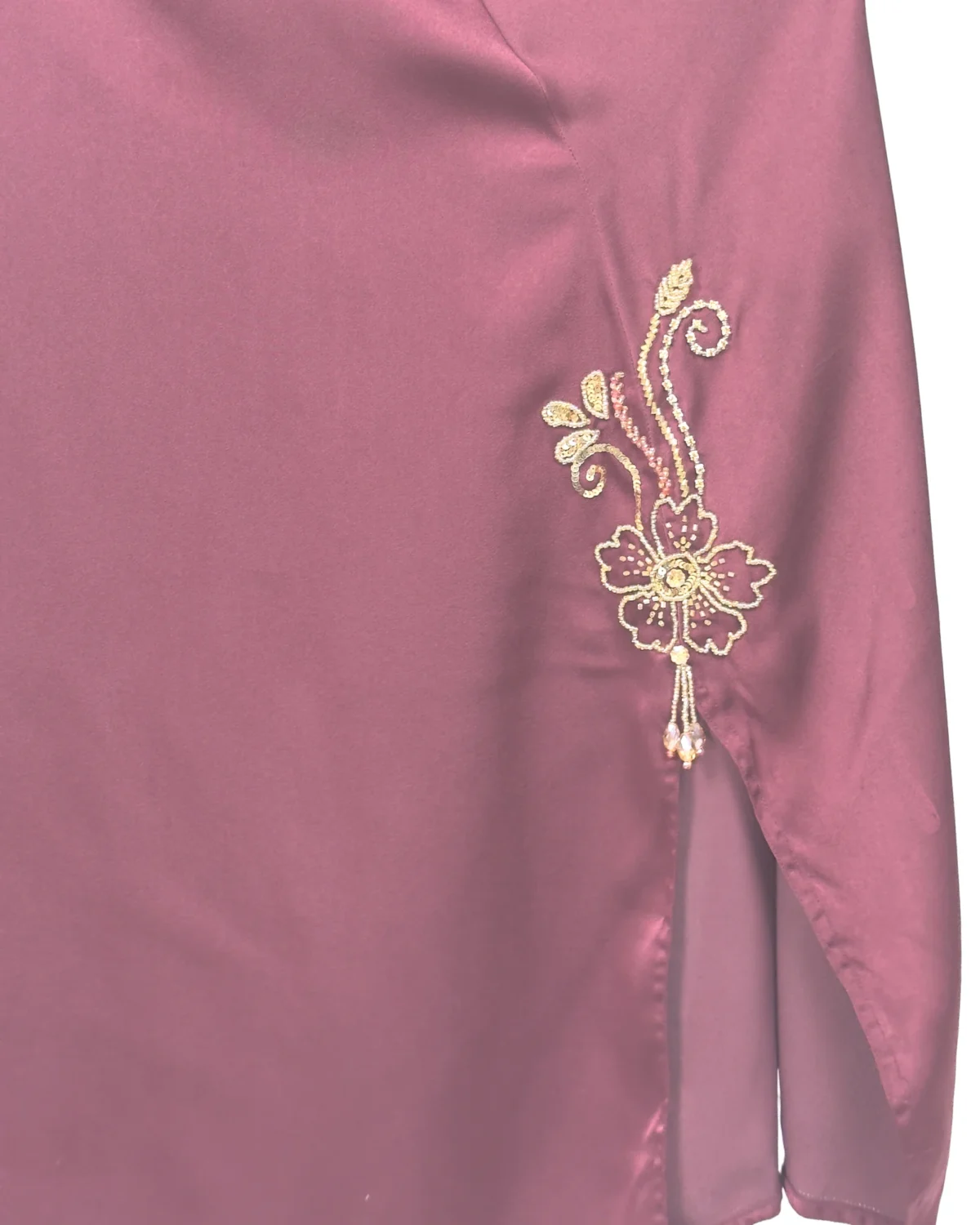 Ruby Bloom deep maroon / wine abaya close-up of the hand-beaded gold floral motif at the hem slit