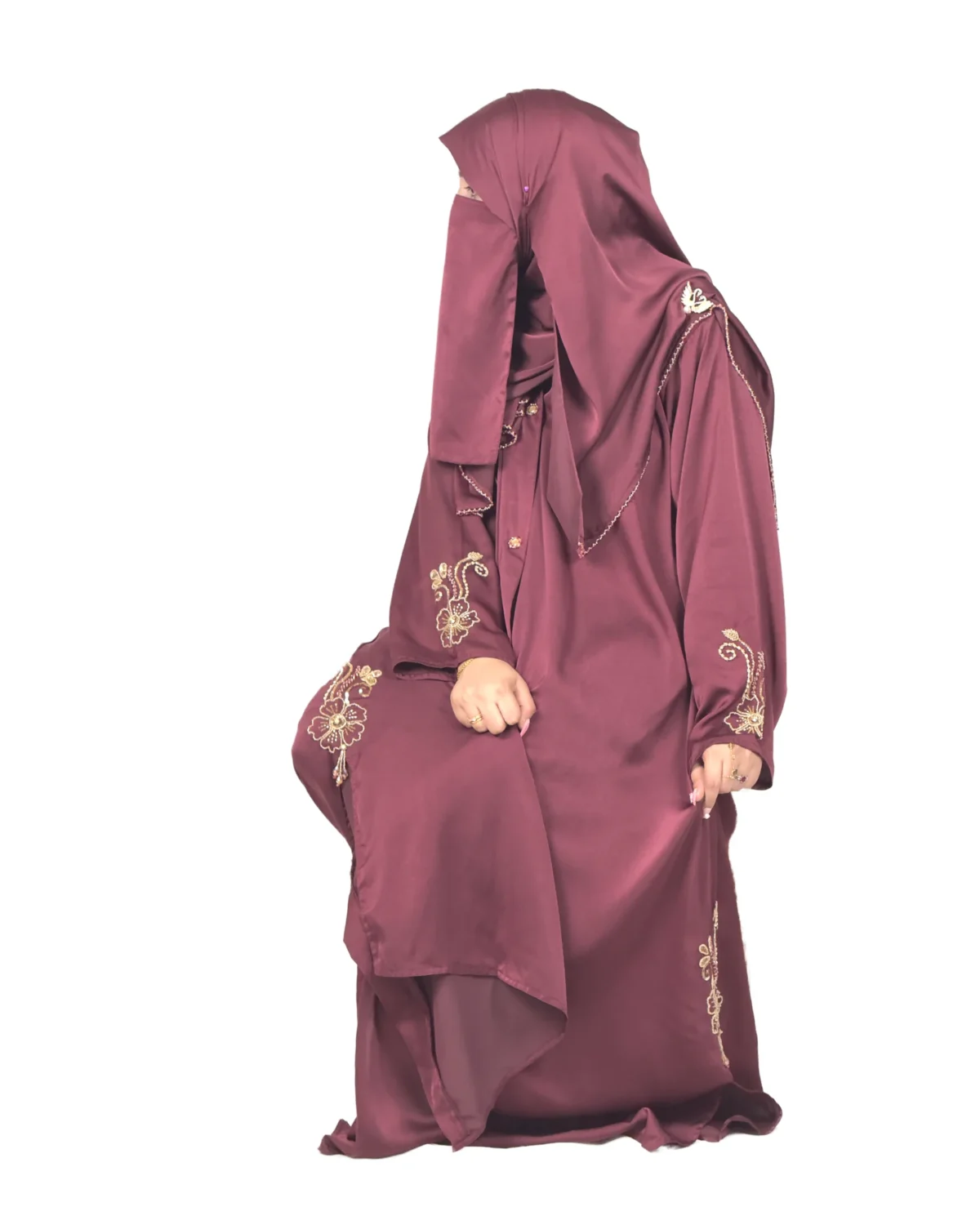 Ruby Bloom deep maroon / wine abaya front three-quarter view with hand-beaded gold floral motifs on the cuffs and hem slits