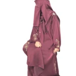Ruby Bloom deep maroon / wine abaya front three-quarter view with hand-beaded gold floral motifs on the cuffs and hem slits